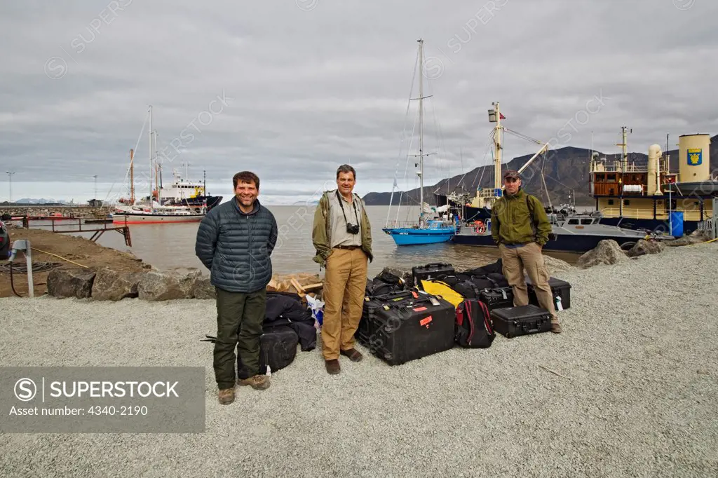 Three photographers arrive for a chartered sailboat expedition circumnavigating the Svalbard archipelago in summertime, Norway.