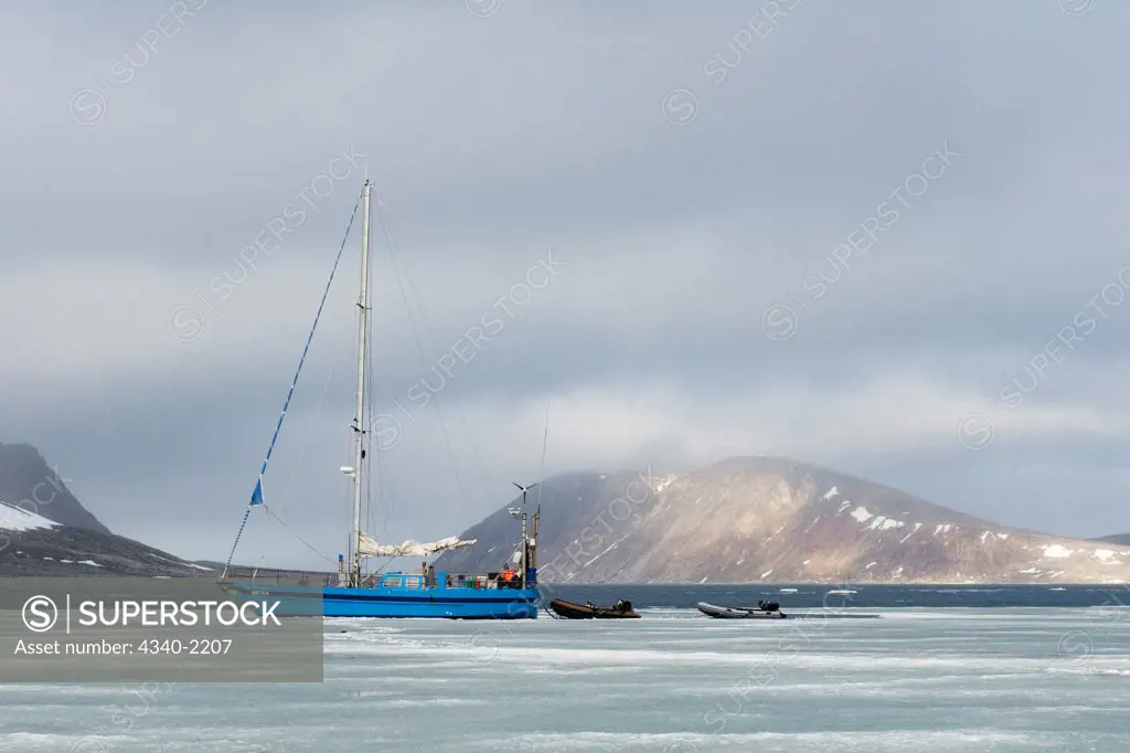 Photographers travel via a steel-hull sailboat to circumnavigate the Svalbard archipelago in summertime, Norway.