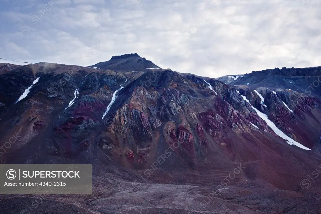 Erosion unearths and exposes color mineral deposits along the coast of Svalbard, Norway, in summertime.