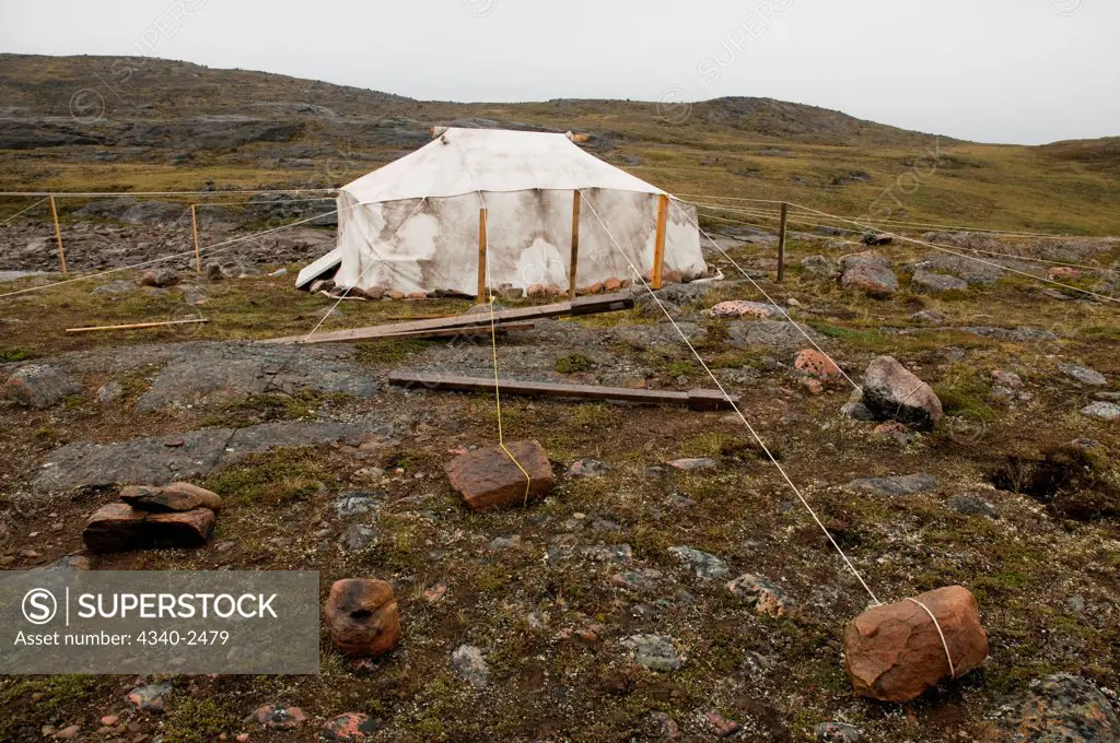 Scientific base camp tent secured heavily by stones due to the occassion of strong winds, Sylvia Grinnell Territorial Park, outside the capital city of Iqaluit, Baffin Island, Nunavut Territory, Canada