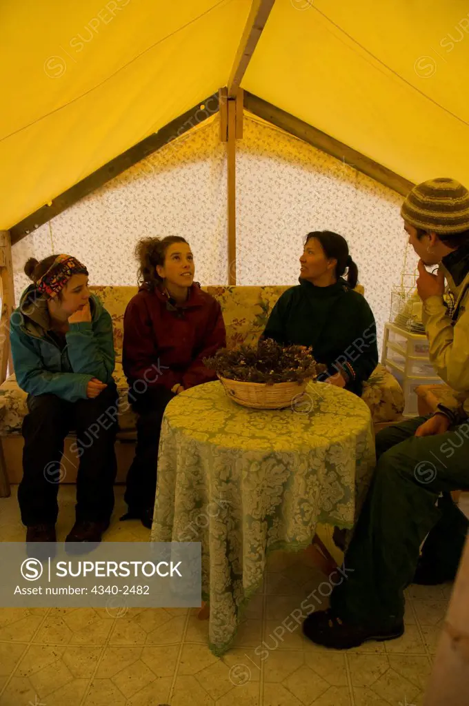 ArcticNet scientists meet with a local Inuit woman in  a tent at a scientific base camp along the Sylvia Grinnell River, Sylvia Grinnell Territorial Park, outside the capital city of Iqaluit, Baffin Island, Nunavut, Canada