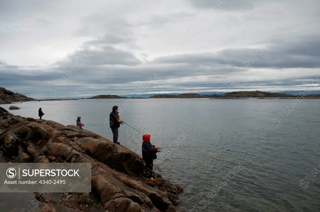 Locals fish for arctic char in the Sylvia Grinnell river in summer, Sylvia Grinnell Territorial Park, Baffin Island, Nunavut, Canada