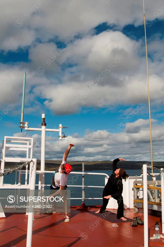 Researchers stretch and do yoga on an upper deck aboard the CCGS Amundsen, a coast guard ship where scientific research is conducted, Iqualuit, Nunavut, Baffin Island, Canada