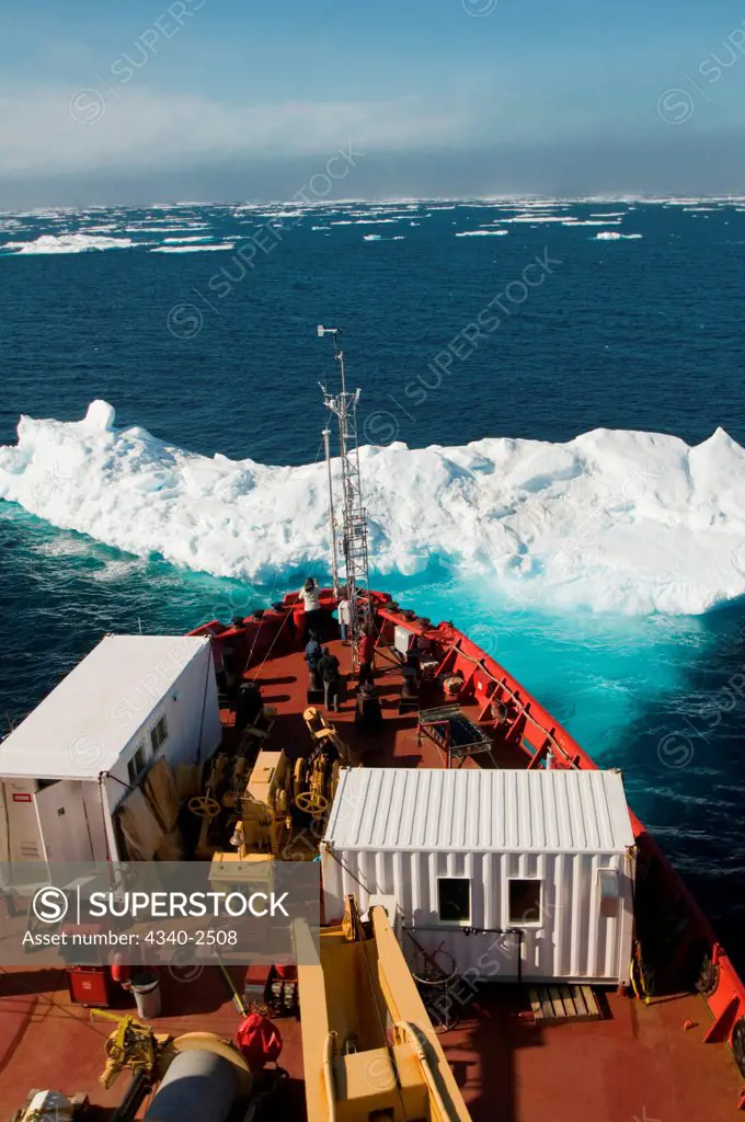 Iceberg floating off the bow of the CCGS Amundsen, a coast guard ship where scientific research is conducted, as it travels through the Northwest Passage in summer, northwest of Baffin Island, Nunavut, Canada