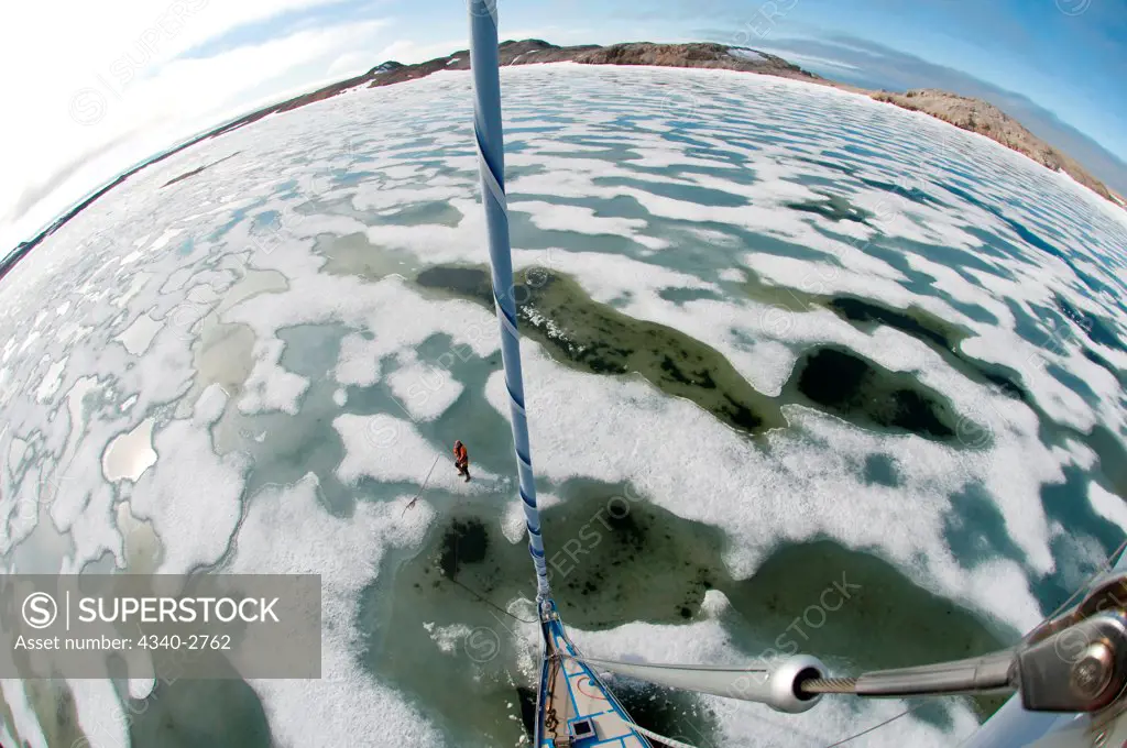Fisheye view from mast of an expedition sailing yacht motoring through sea ice, Spitsbergen, Svalbard Archipelago, Norway, Summer