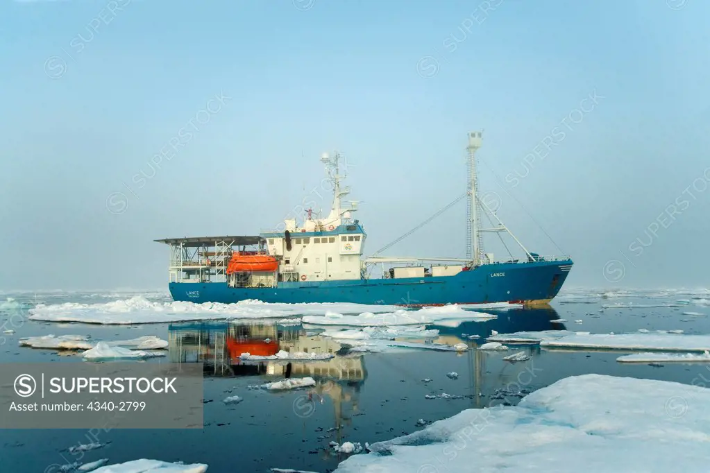 research ship sits amidst unusual sea ice amassed outside Longyearbyen, before it breaks ice for a caravan of ships, located in Isfjorden, western Spitsbergen, Svalbard Archipelago, Norway