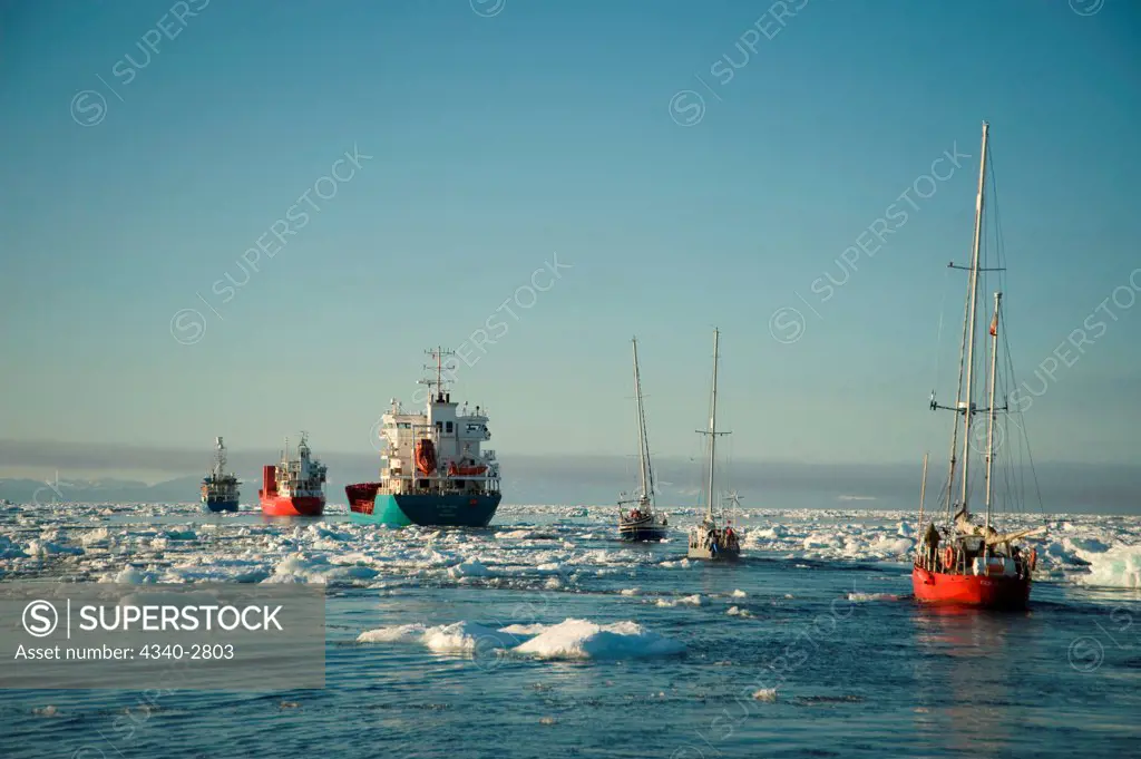 caravan of ships break through unusual sea ice amassed outside Longyearbyen in July, located in Isfjorden, western Spitsbergen, Svalbard Archipelago, Norway