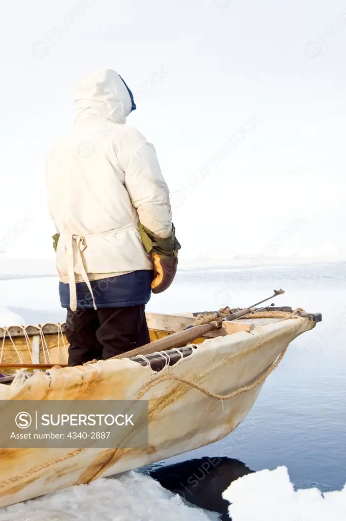 USA, Alaska, Inupiaq whaler standing at front of umiak