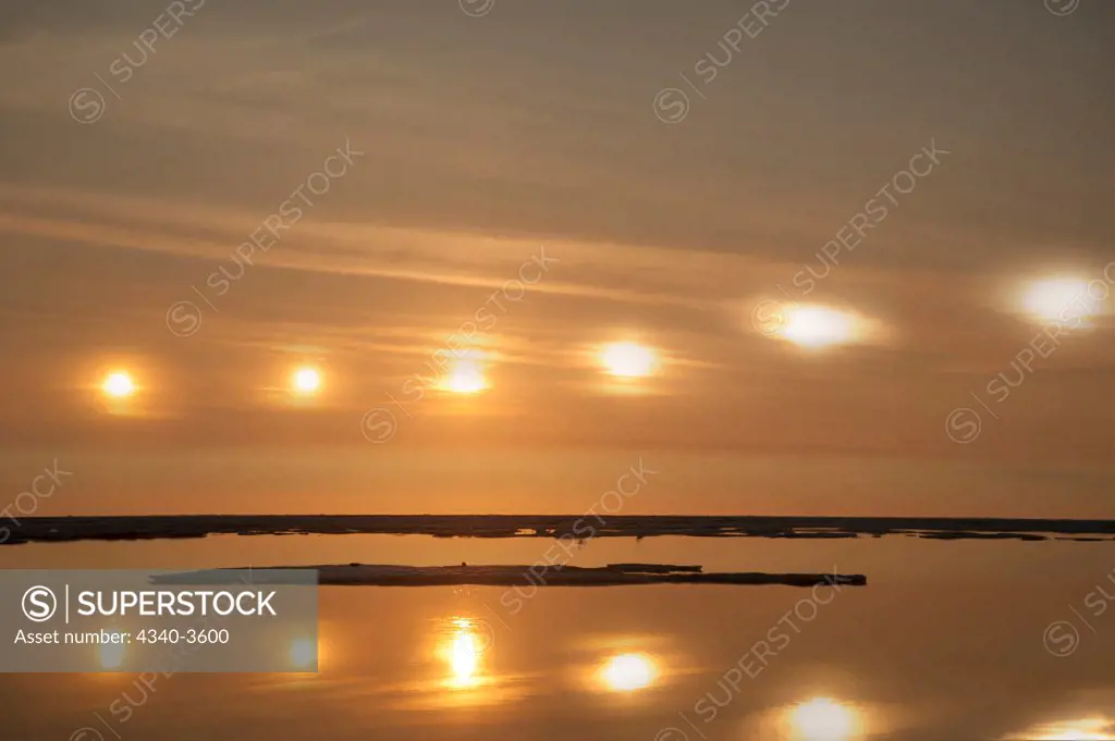 USA, Alaska, North Slope, Arctic National Wildlife Refuge, Beaufort Sea, Scenic landscape of sun reflecting in light clouds