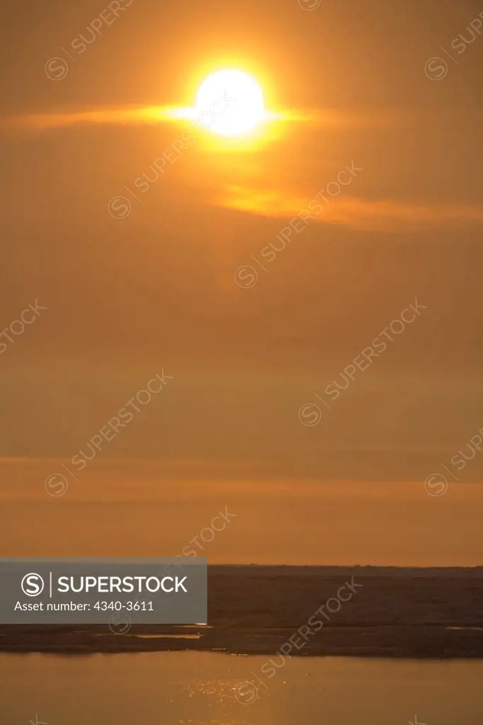USA, Alaska, North Slope, Arctic National Wildlife Refuge, Beaufort Sea, Scenic landscape of sun reflecting in light clouds
