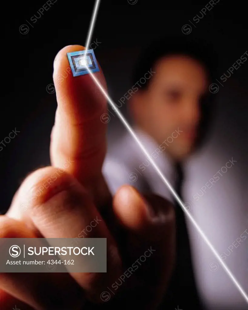 Laser Bouncing Off of a Computer Chip on a Man's Finger