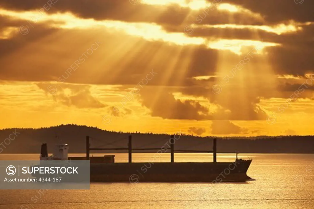 A Cargo Ship Bathed Sunrays