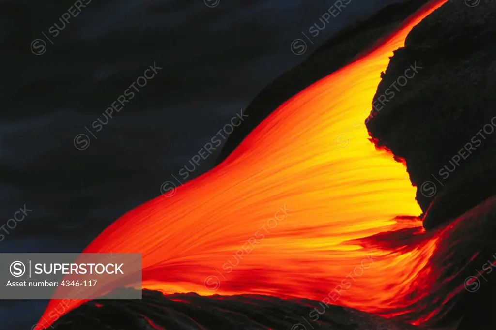 A River of Molten Pahoehoe Lava Moving Quickly Over a Ledge