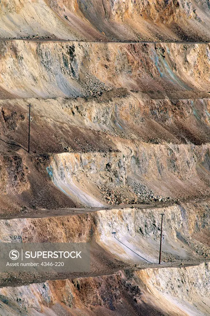 Power Lines Hop Up the Side of An Enormous Open Pit Mine
