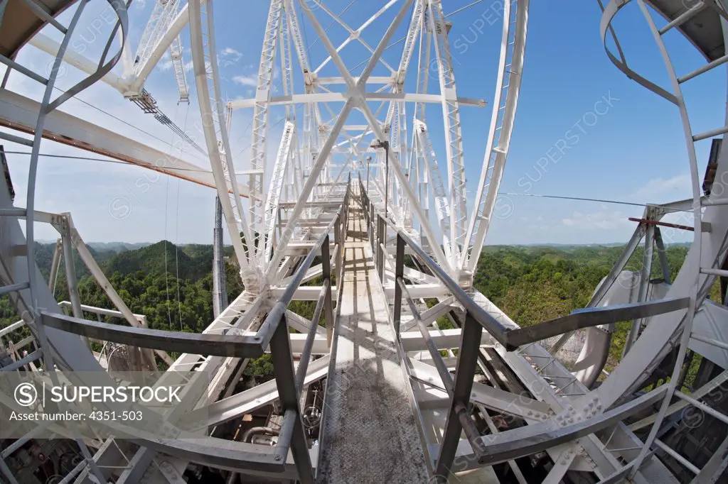 The Arecibo Observatory is a radio telescope just over 1,000 feet (305 m) across, the largest single radio telescope. The main metal collecting dish sits fixed a hemispherical karst sinkhole. The observatory is the primary location of the National Astronomy and Ionosphere Center, NAIC.