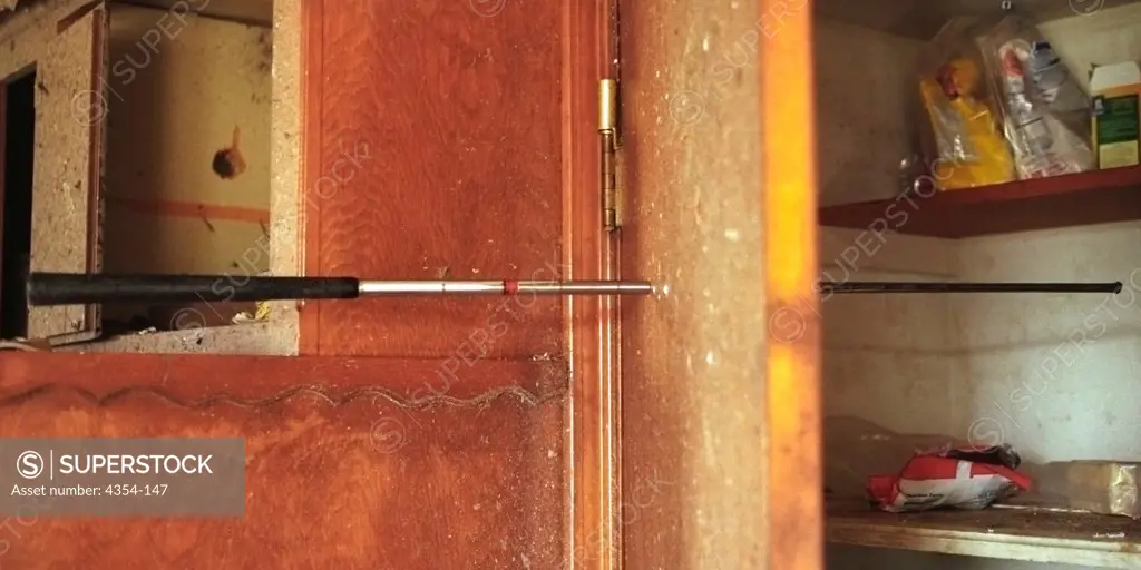 Golf Club Shaft Impaled Through Kitchen Closet Door