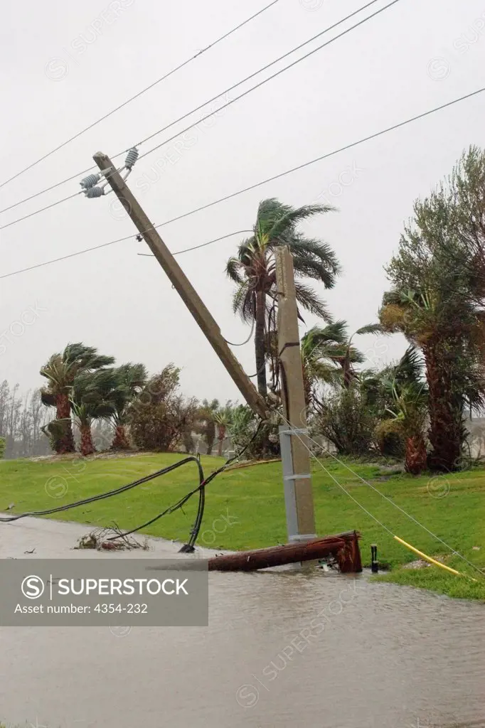 A Utility Pole Dangles by Lines After Being Snapped by Jeanne's Winds