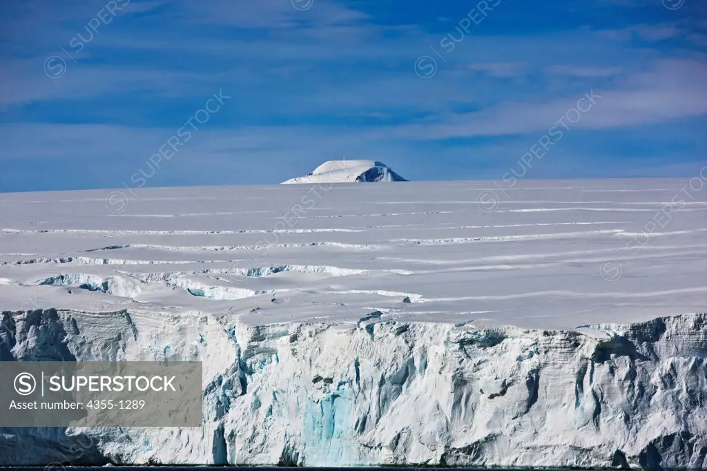 Mountain Peeking Over Ice Shelf