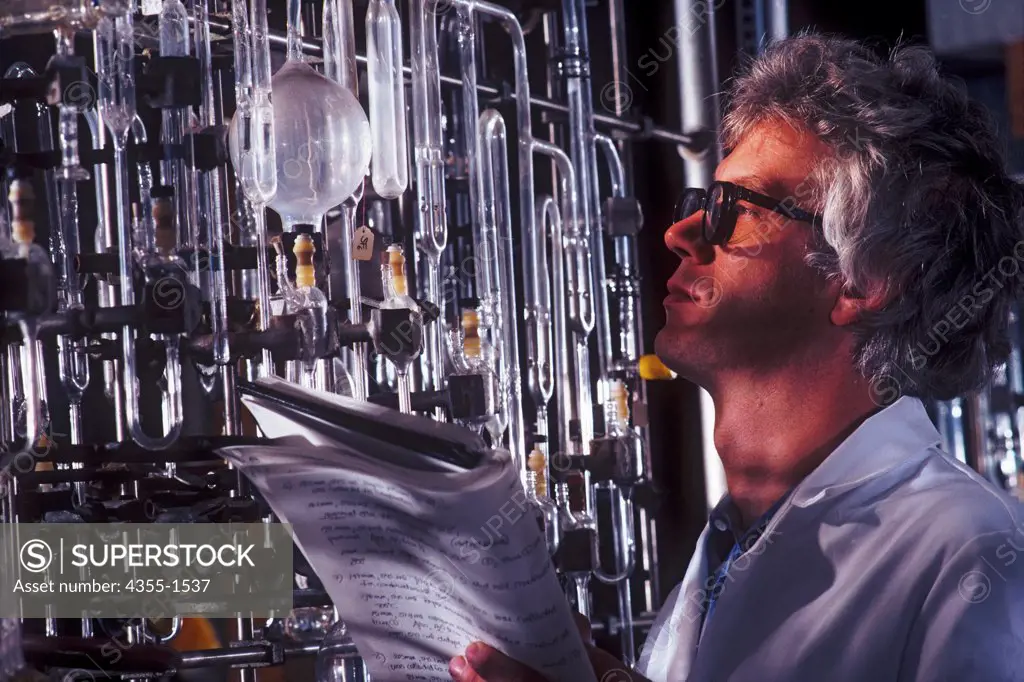 A biochemist studies a flask in a laboratory.