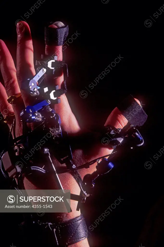 Artificial reality equipment on a person's hand.