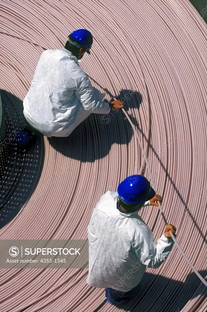 Communication workers with fiber optic cable.