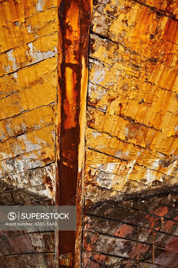 The hull of an aging boat in the Port of Reykjavik, in Iceland. The port is a strategic centre of maritime services and cargo handling, not only for Iceland but also for the entire North Atlantic region. Reykjavik has become a popular destination for cruise vessel and is still an active commercial fishing and whaling port and has a substantial shipyard.
