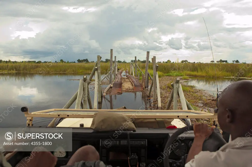 An off-road vehicle crosses a swamp on an old bridge in the Okavango Delta, in Botswana, the world's largest inland delta.
