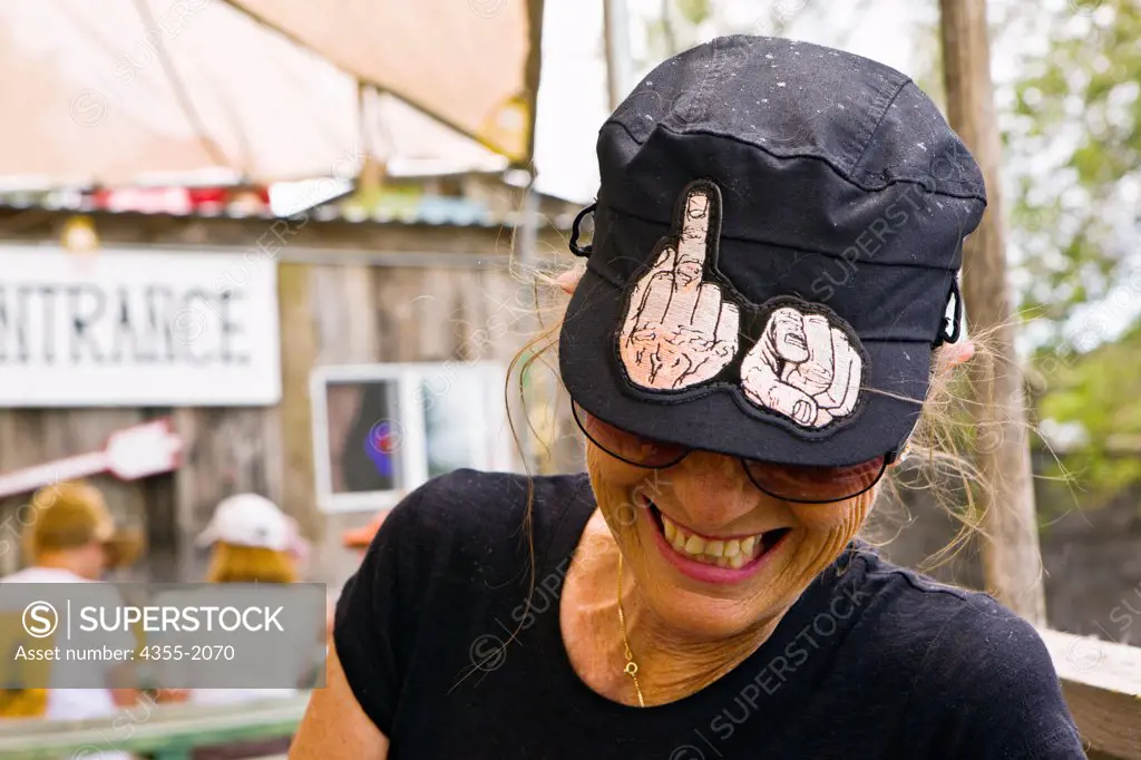 A woman happily displaying her offensive hat.