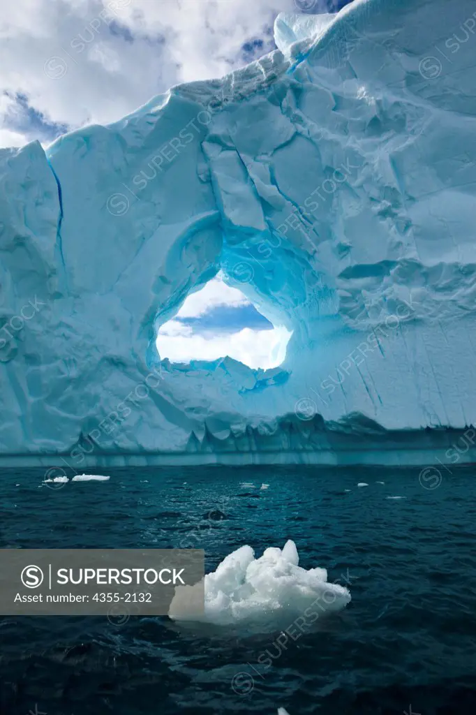 A large arch in a tabular iceberg off of Danko Island in Antarctica
