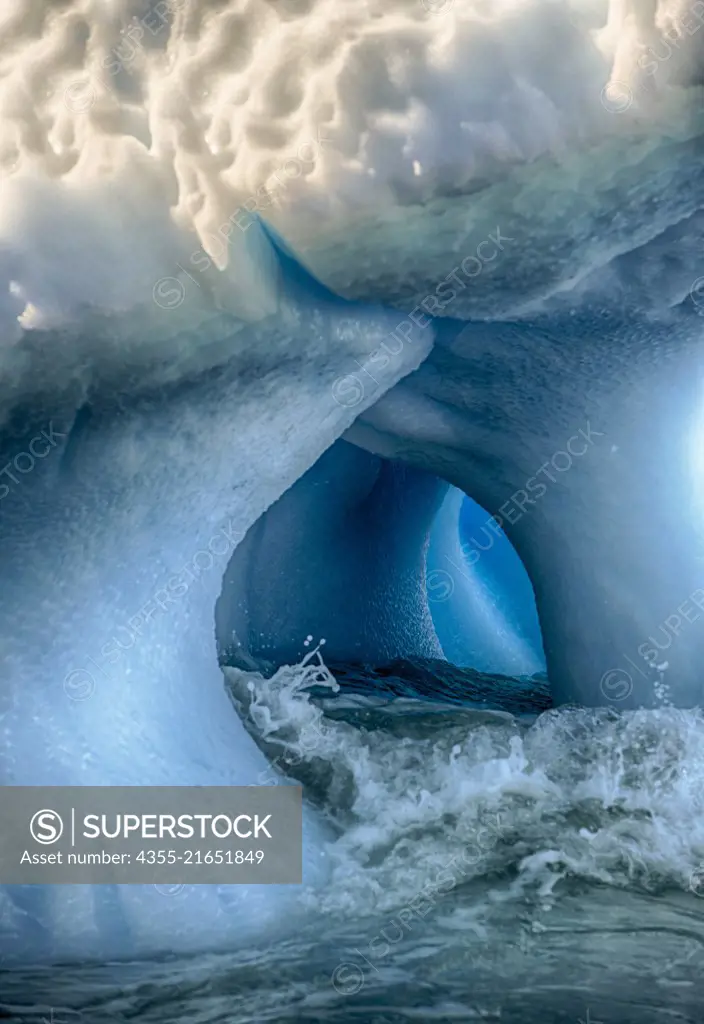 A tunnel into the depths of an iceberg off of Cuverville Island, Antarctica