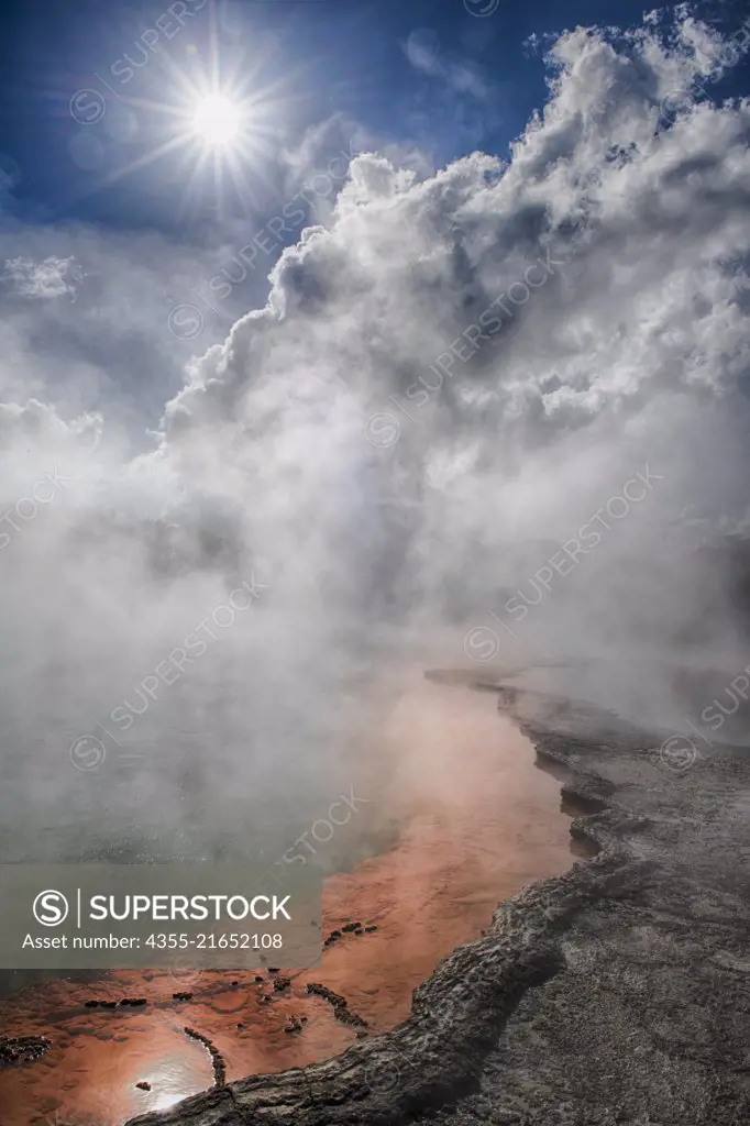 The Champagne Pool is near Rotorua on New Zealands North Island. Bubbling CO2 rises from the deep green of the spring, while heavy metal sulphides precipitate at the edges to form a brilliant orange ring.