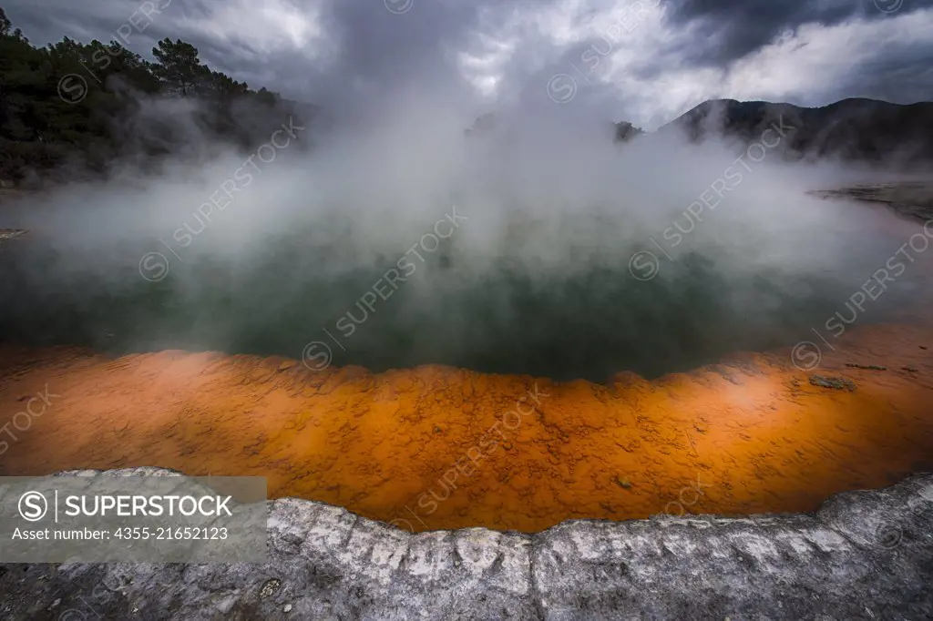 The Champagne Pool is near Rotorua on New Zealands North Island. Bubbling CO2 rises from the deep green of the spring, while heavy metal sulphides precipitate at the edges to form a brilliant orange ring.
