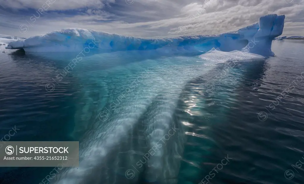 A spectacular view of an iceberg extending deep beneath the surface near Vernadsky Station in Antarctica