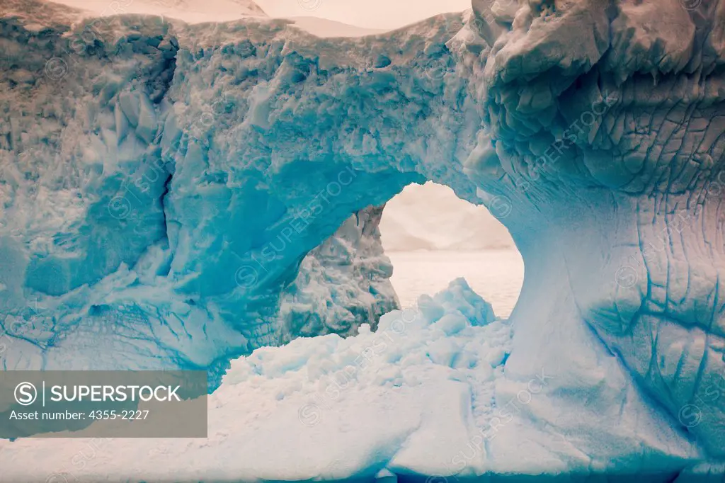 An hole in a large tabular iceberg in Wilhelmina Bay, Antarctica