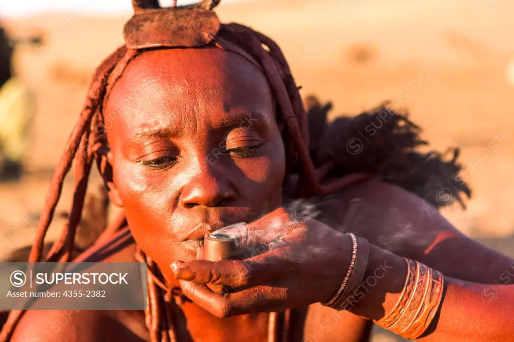 Namibia, Serra Cafema, Close-up of Himba woman smoking pipe