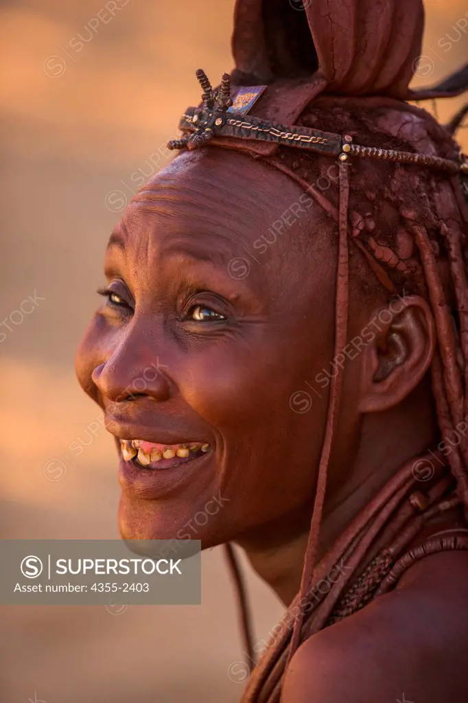 Namibia, Serra Cafema, Close-up of Himba tribe woman in traditional headwear laughing
