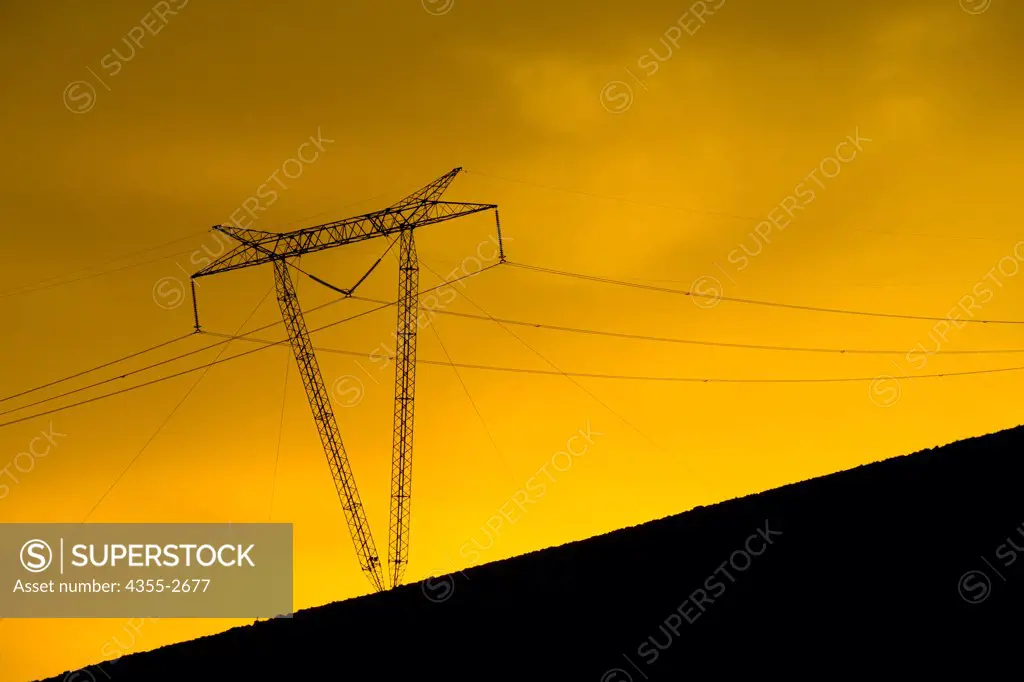 Argentina, Electricity pylon in Salted Mountains of San Pedro de Atacama, An epic sunset in Salted Mountains of San Pedro de Atacama of Argentina. Atacama Desert is plateau in South America, covering 1, 000-kilometre strip of land on Pacific coast, west of Andes mountains.