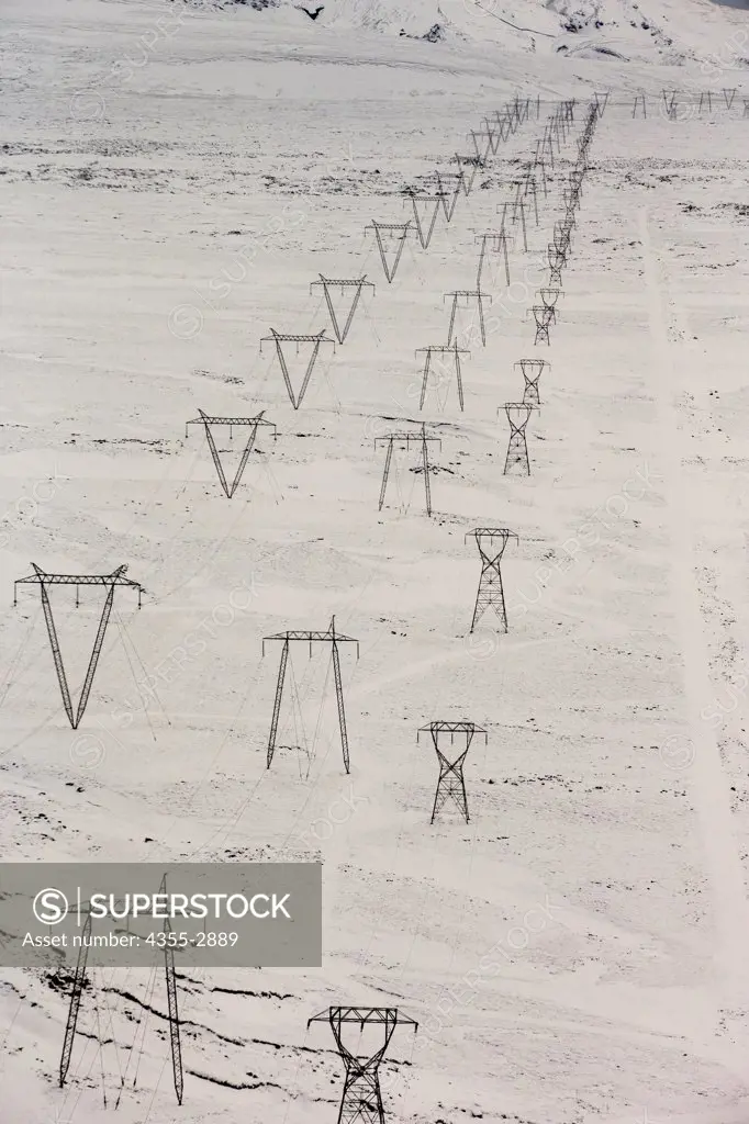 Electricity pylons on a snow covered landscape, Reykjavik, Iceland