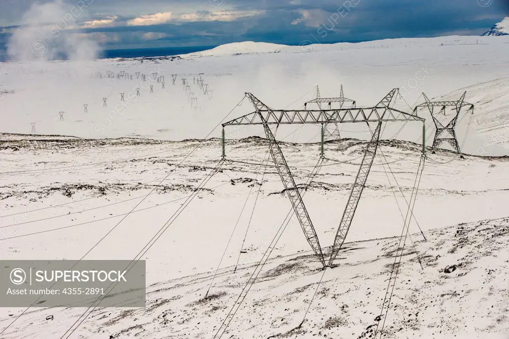 Electricity pylons on a snow covered landscape, Reykjavik, Iceland