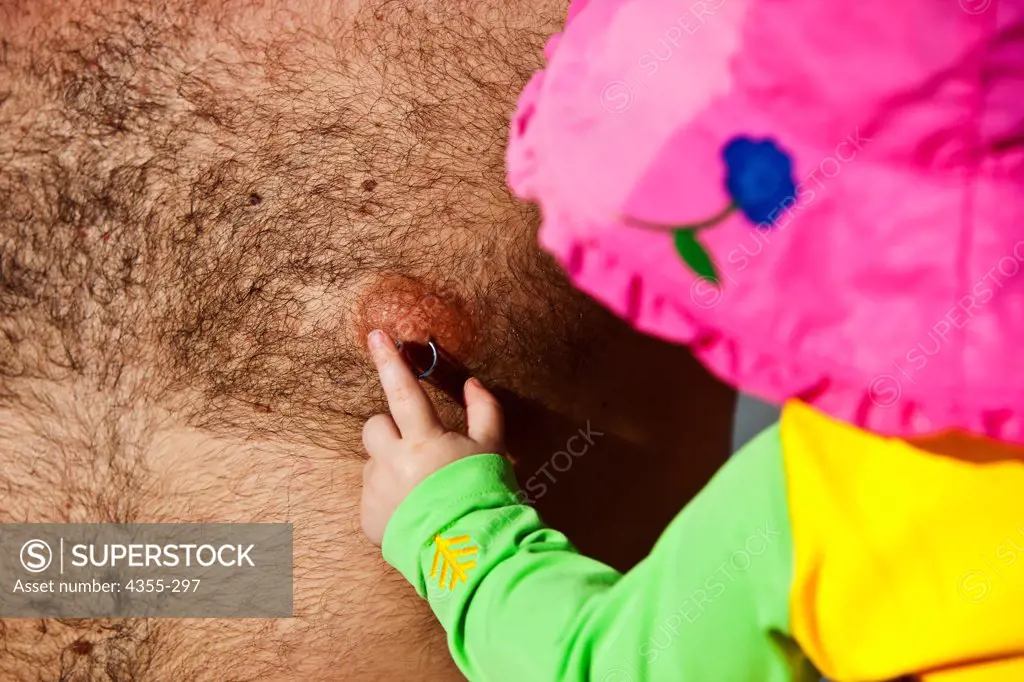 Small Child Examining Nipple Ring