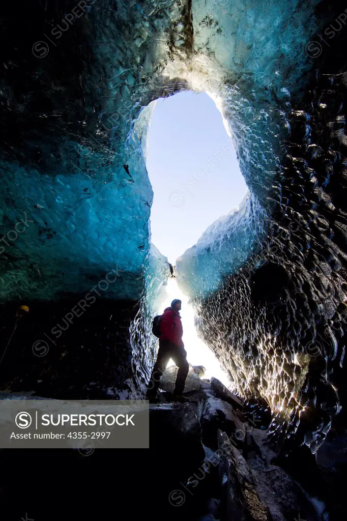 Hiker in an ice cave, Svinafellsjokull, Vatnajokull, Iceland