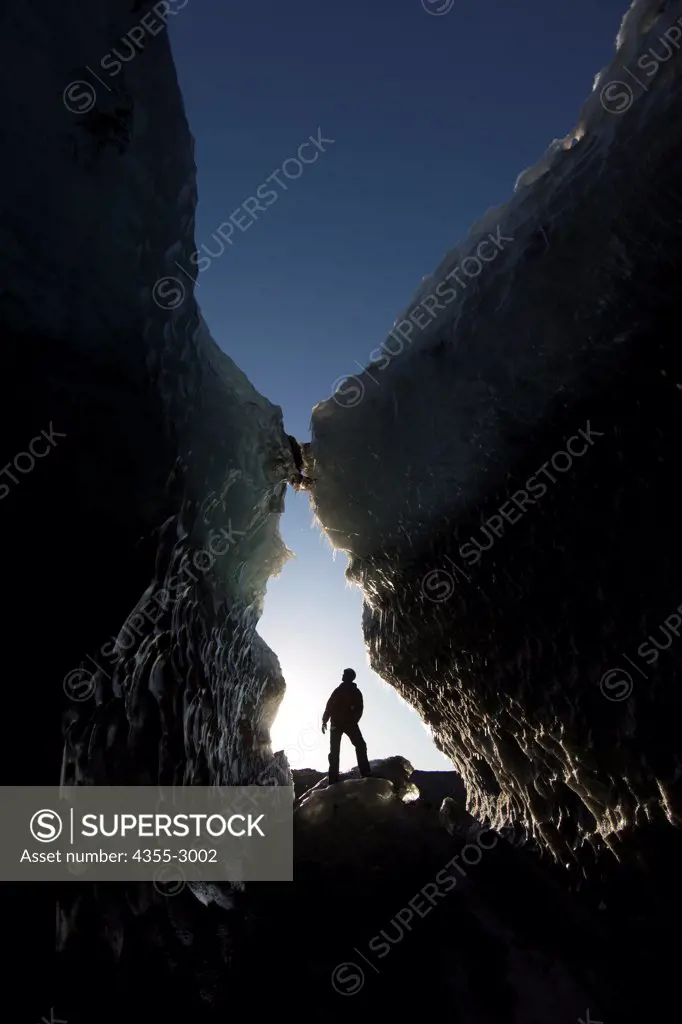 Hiker in an ice cave, Svinafellsjokull, Vatnajokull, Iceland
