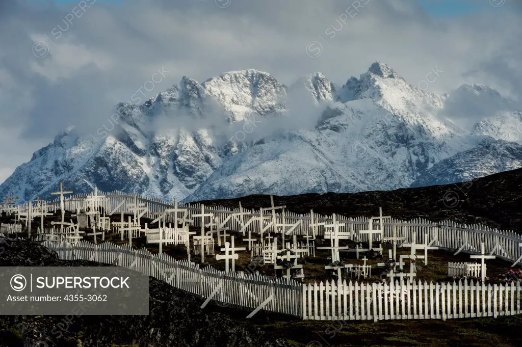 Cemetery with snowcapped mountains in the background, Itilleq, Sisimiut, Greenland