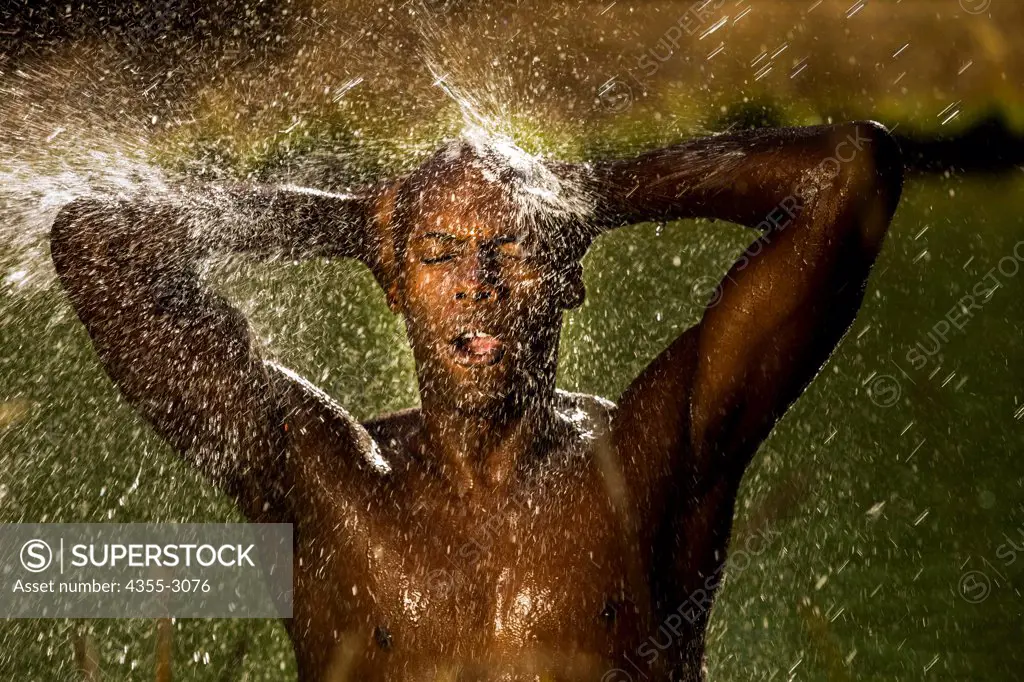African American athlete taking a shower after a swim, Mendocino, California, USA