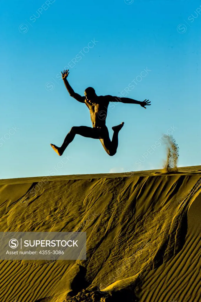 Man jumping on sand, Mendocino, California, USA