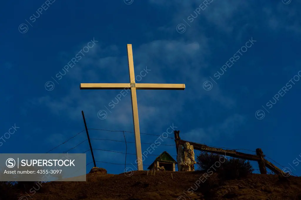 Cross on hillside, Chimayo, New Mexico, USA