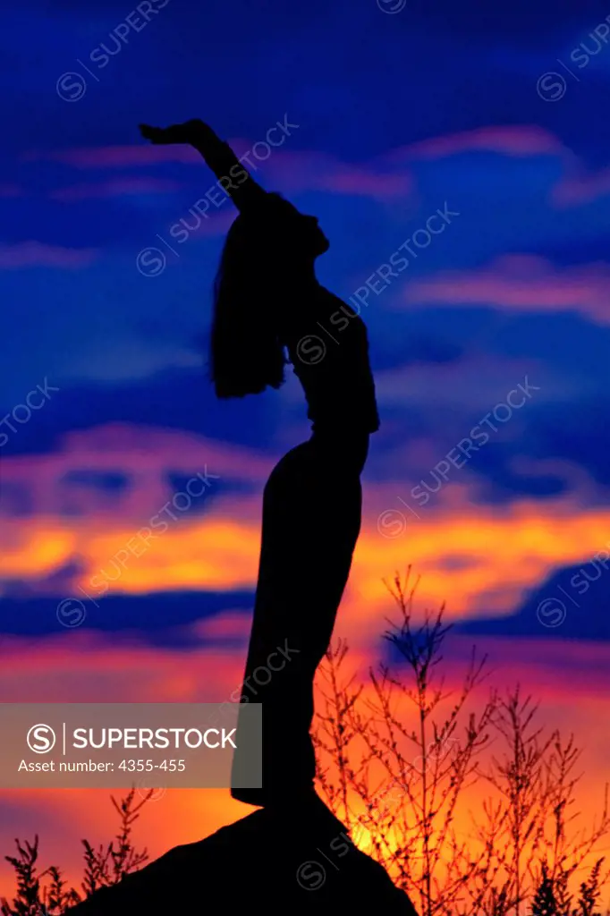 Woman Stretching at Sunrise