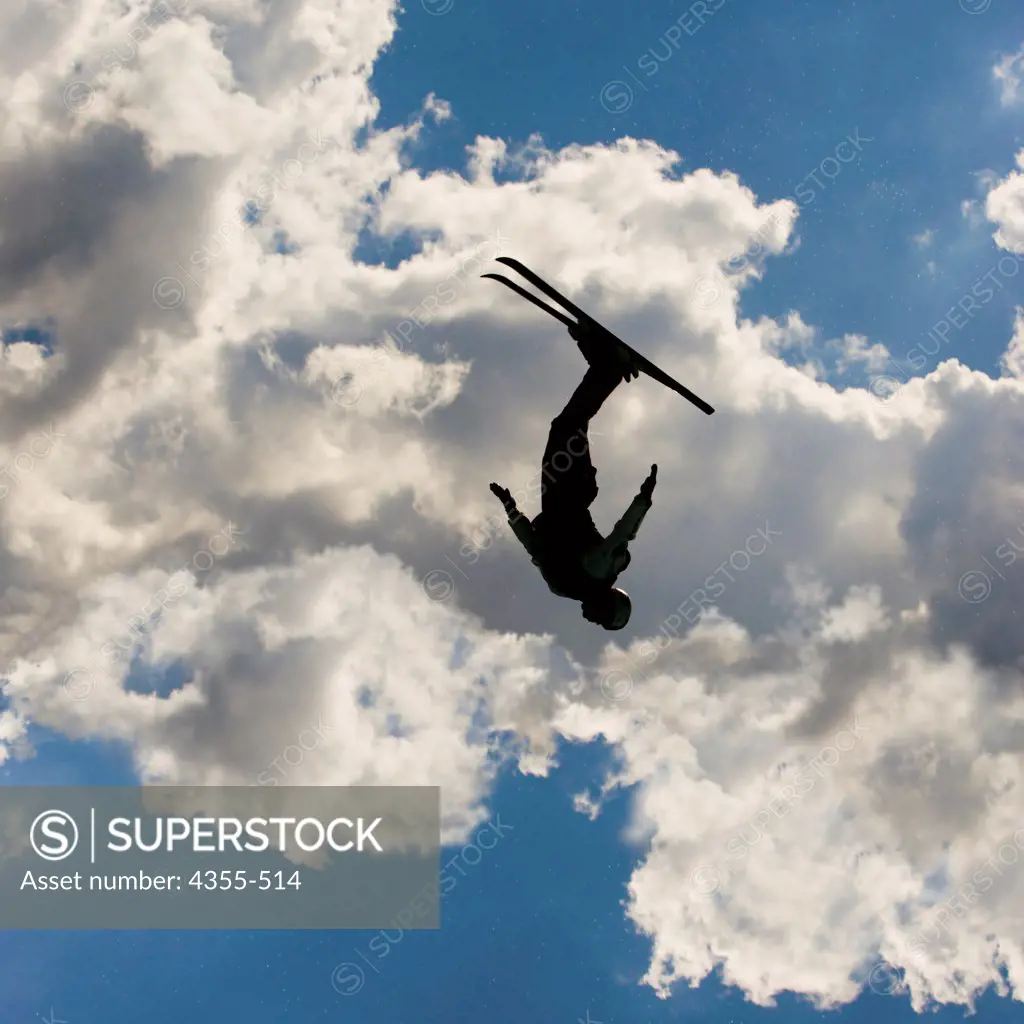 An Aerial Freestyle Ski Jumper Silhouetted in Brilliant Sky