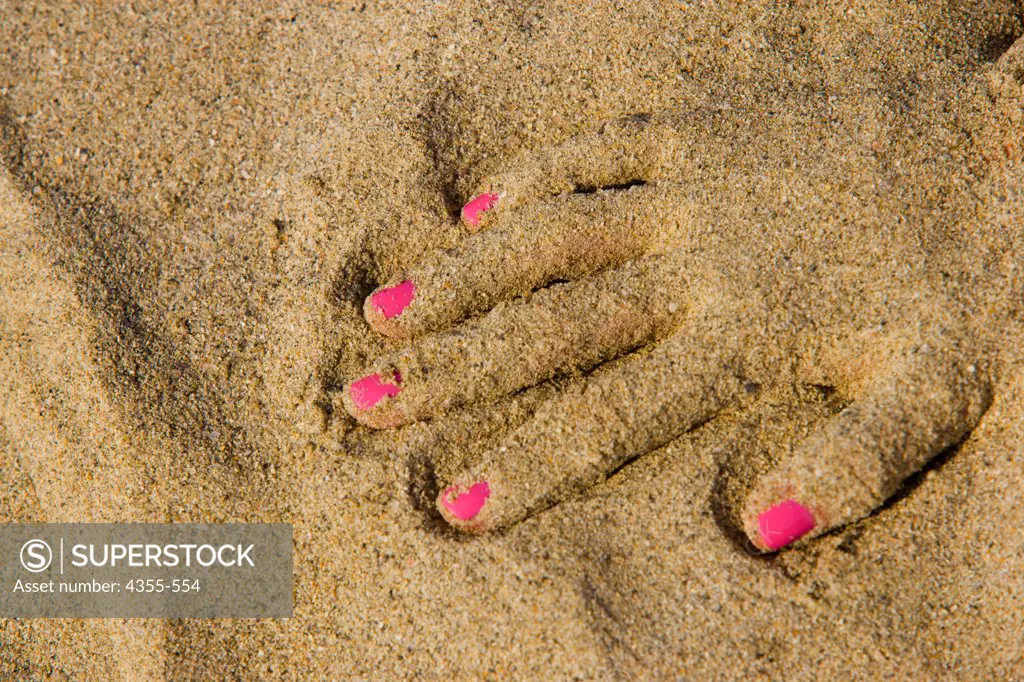 Pink Fingernails Peek Out of the Sand