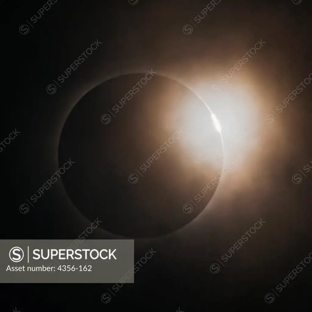 Diamond Ring Effect Peeks Out from Behind Scattered Clouds at the Onset of Totality During Solar Eclipse, July 22, 2009 Near Hangzhou, China